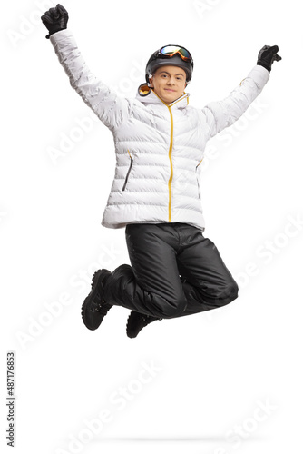 Happy young man in winter clothes jumping