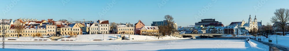 Panoramic view of old building in historical center of Minsk. Historical building and church near the frozen river.