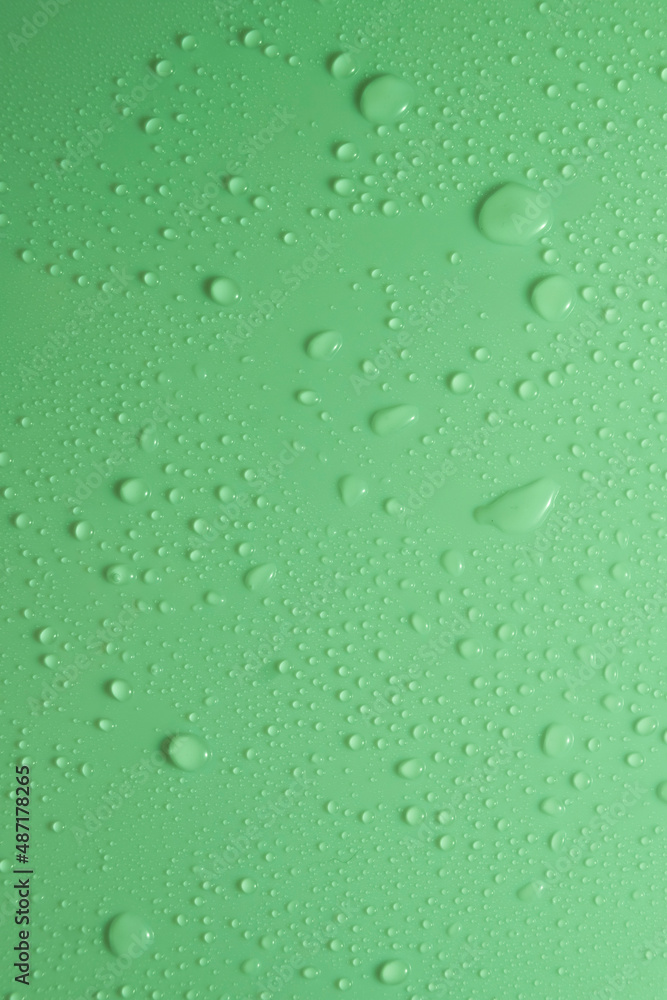 Green pastel water drops on light shiny surface Green pastel water drops on light shiny surface