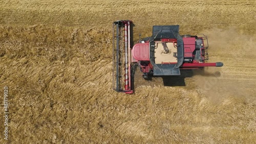 From Above of Agricultural Combine Harvests Wheat in Field in Summer