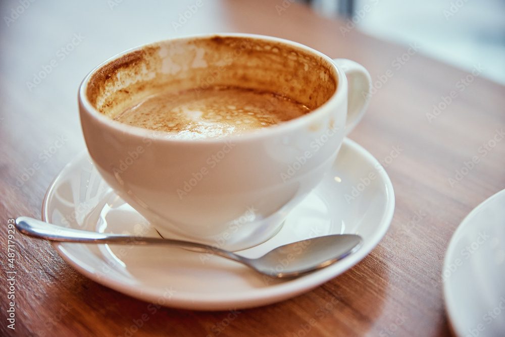 Cup of coffee on cafe table near window, breakfast at public place Cup of coffee on cafe table near window, breakfast at public place