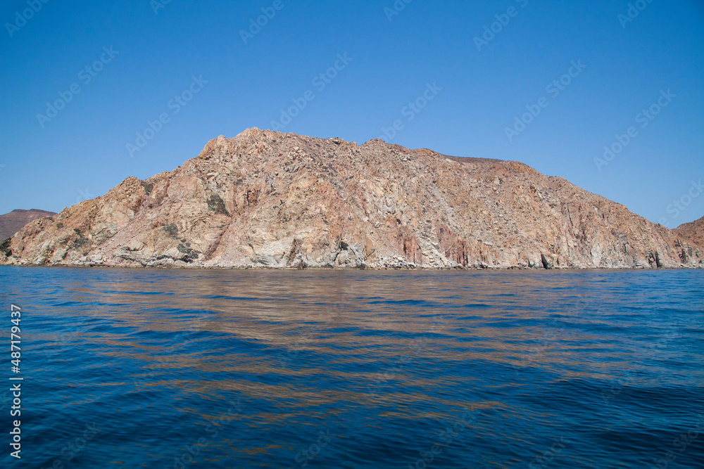 mountainous island surrounded by a blue sea