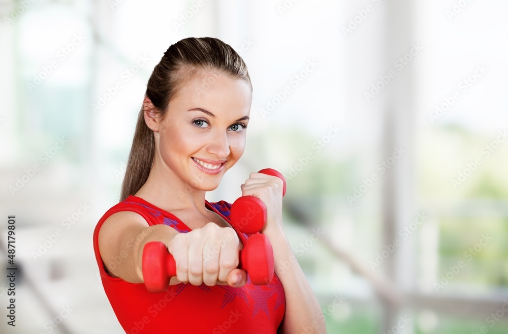 Domestic Training With Weights. Positive lady doing exercises with dumbbells Domestic Training With Weights. Positive lady doing exercises with dumbbells