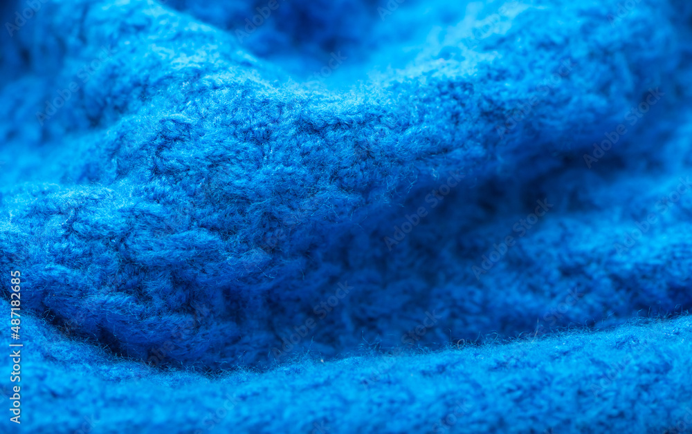 Knitted surface of woolen things as a background. Close-up of soft blue knitted patterns texture. Warm winter clothes. Background textile surface with copy space for text. Knitted surface of woolen things as a background. Close-up of soft blue knitted patterns texture. Warm winter clothes. Background textile surface with copy space for text.