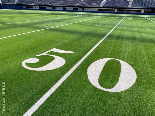 American football field, empty, no crowd with yard line numbers. 50 yard line highlighted.