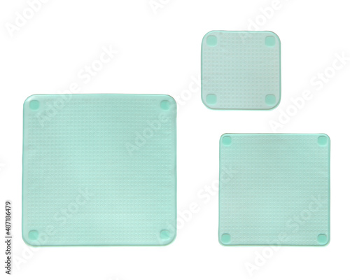 Three different sized silicone square stretch lids insulated on white background