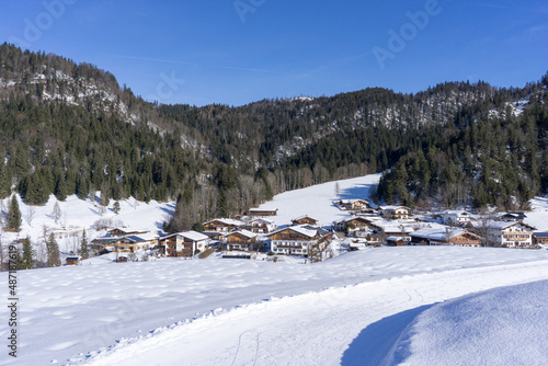 houses of a mountain village during winter with a lot of snow