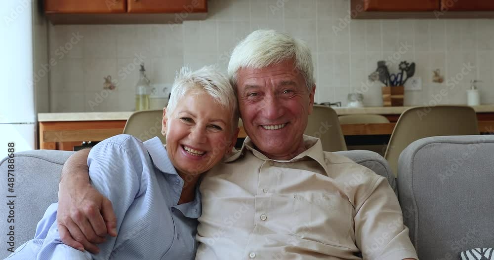Cheerful mature couple talking to grown up children use video conference app, smile look at camera laughing enjoy distance communication. Older gen and easy comfort usage of modern technology concept Cheerful mature couple talking to grown up children use video conference app, smile look at camera laughing enjoy distance communication. Older gen and easy comfort usage of modern technology concept