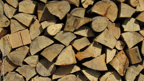 stack of firewood. Chopped wooden logs stacked in the woodpile