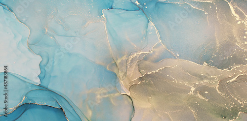 Abstract alcohol ink painting texture in blue azure tones with golden splashes