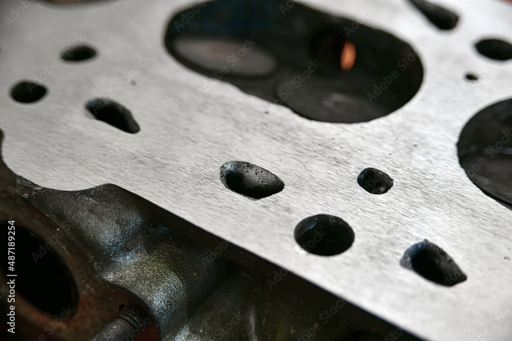 Aligned and ground cylinder head with an abrasive stone on a surface grinder. Aligned and ground cylinder head with an abrasive stone on a surface grinder.