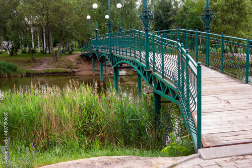 Beautiful openwork bridge with lanterns across the river
