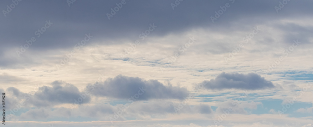 Dark cumulus clouds in the bright evening sky