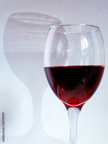 Glass of red wine with shadow