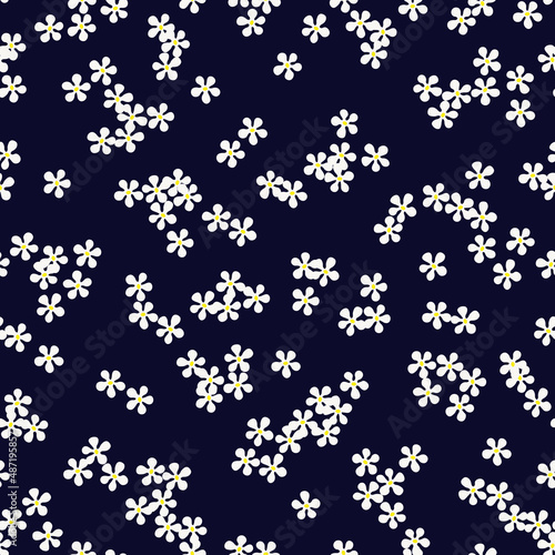 Obraz na płótnie Floral seamless pattern with small white daisy flowers on dark blue background. Ditsy print. Cute plain chamomile florets design for trendy fabric, textile and wallpaper. Vector illustration. w salonie