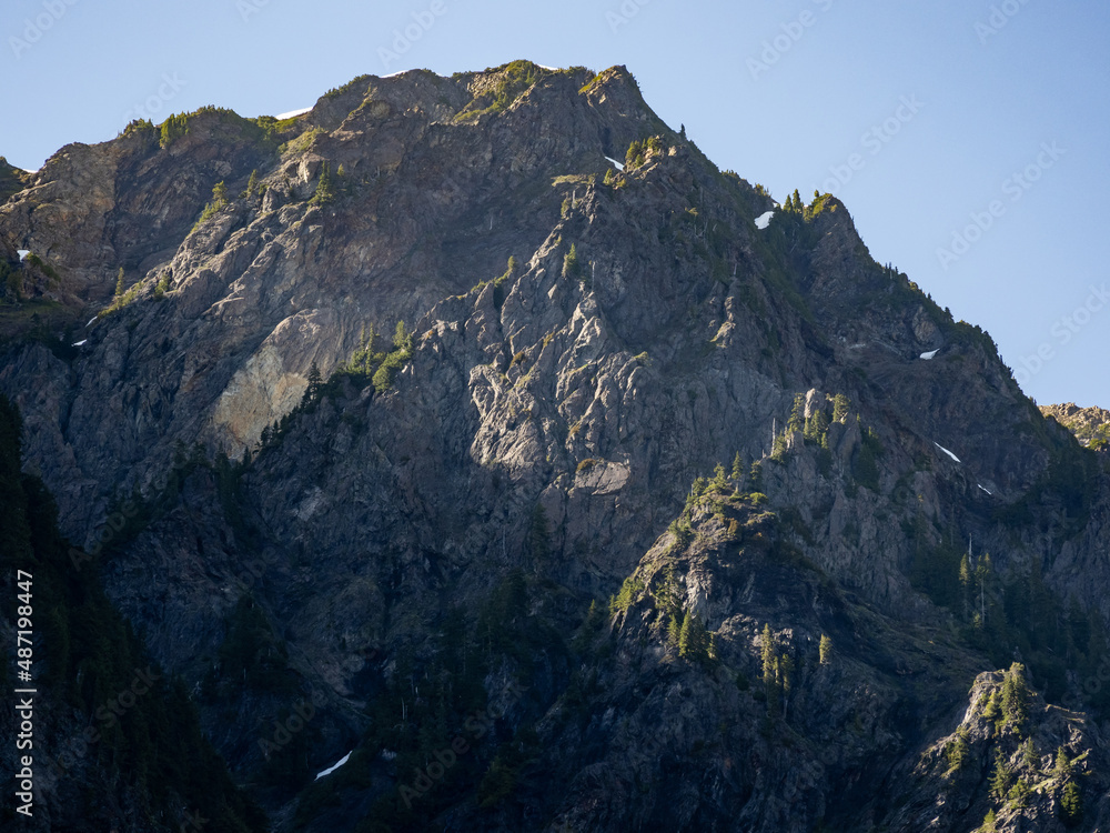 Fototapeta premium Sunrise on the mountains towering over Enchanted Valley in Olympic National Park, forest covered ridges.