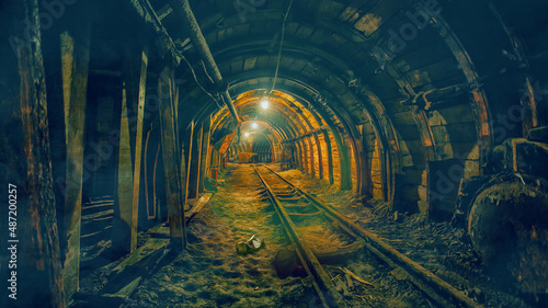 Obraz na plátně Old underground abandoned coal mine with lights and rails