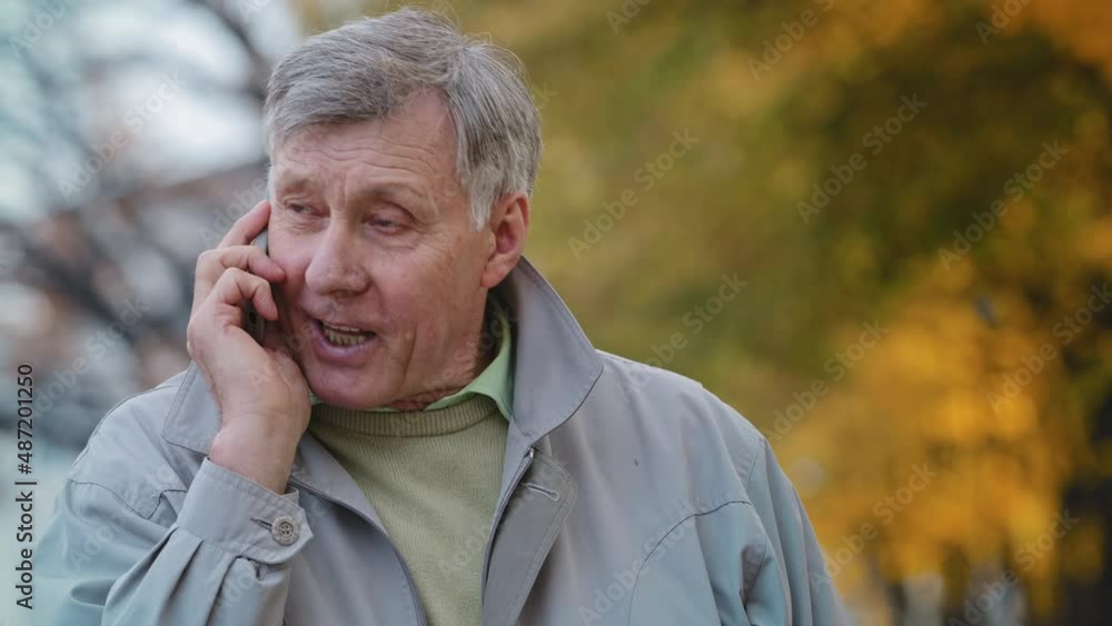 Portrait mature elderly man pensioner communicate remotely using modern smartphone talking family or friends order delivery happy old senior laughing outdoors discussing good health with family doctor Portrait mature elderly man pensioner communicate remotely using modern smartphone talking family or friends order delivery happy old senior laughing outdoors discussing good health with family doctor