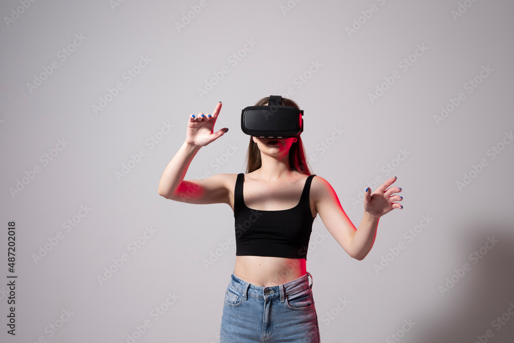 Designer, architect, developer or engineer woman wearing VR goggles and interacts with cyberspace using swipe and stretching gestures while working on a new perspective project. Designer, architect, developer or engineer woman wearing VR goggles and interacts with cyberspace using swipe and stretching gestures while working on a new perspective project.