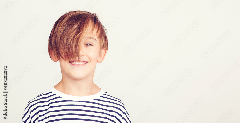Happy boy with stylish hairstyle. Happy childhood and positive emotions. Portrait of handsome boy. Happy boy with stylish hairstyle. Happy childhood and positive emotions. Portrait of handsome boy.