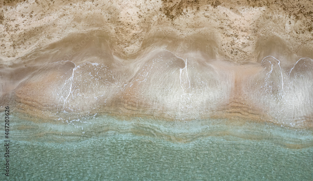 Aerial view drone of empty tropical sandy beach with golden sand. Seascape background