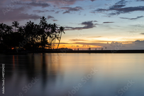 Sunset with palms at Waikoloa Beach with colorful skies, Big Island, Hawaii