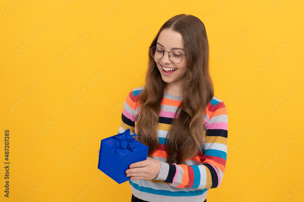 happy teen girl in eyeglasses hold present box for holiday, shopping happy teen girl in eyeglasses hold present box for holiday, shopping
