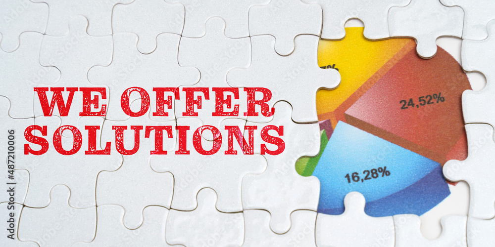On white puzzles there is an inscription - We offer solution. Financial diagram in the window among the puzzles On white puzzles there is an inscription - We offer solution. Financial diagram in the window among the puzzles