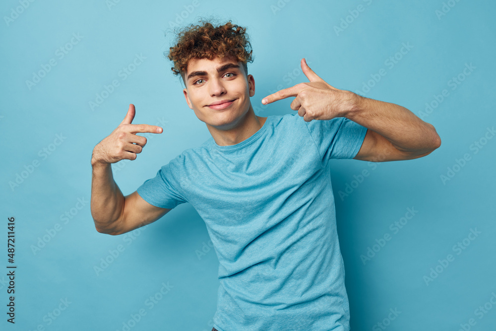 handsome guy in blue t-shirts with a pumped-up body unaltered handsome guy in blue t-shirts with a pumped-up body unaltered