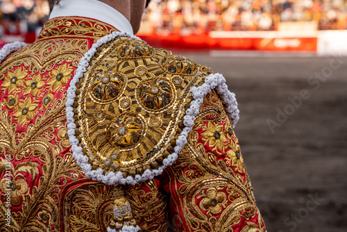 bullfighter on his back looking at the bull