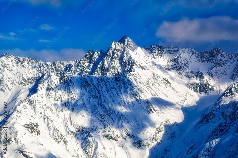 Obraz premium Austrian Alps mountain peaks covered with snow during winter time.