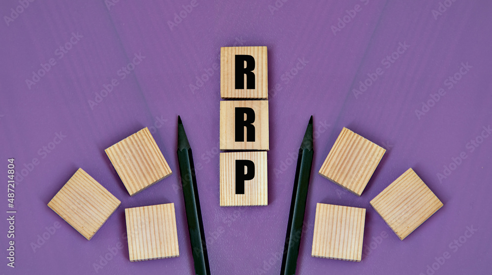 RRP - acronym on wooden cubes with pencils on a purple background