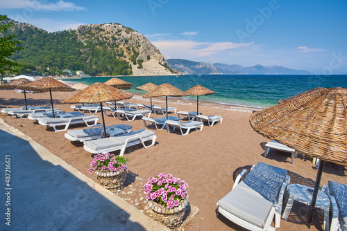 Fototapeta Naklejka Na Ścianę i Meble -  sandy beach without people and with sun loungers, umbrellas, palm trees, Marmaris