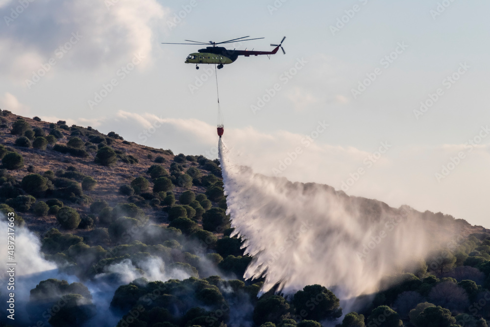 Fototapeta premium helicopter flying over the mountains