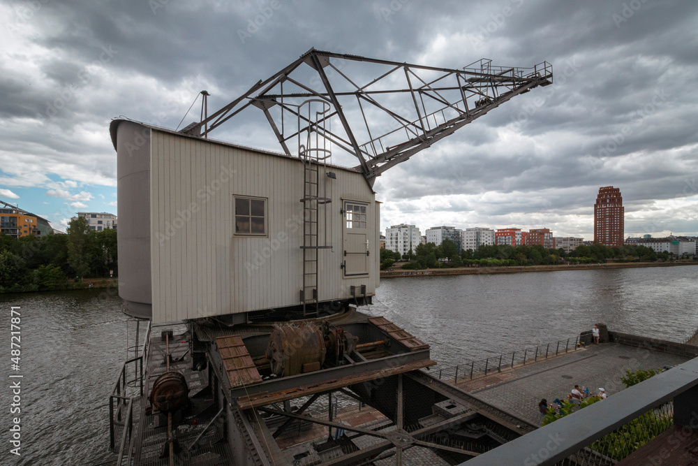 Very old construction crane with clouds Very old construction crane with clouds
