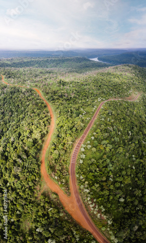 aerial photography from a drone of an asphalt road and a red dirt road in the middle of the Misiones jungle of Argentina