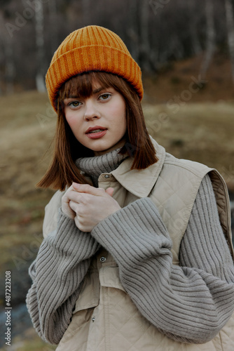 young woman in an orange hat nature autumn landscape © SHOTPRIME STUDIO