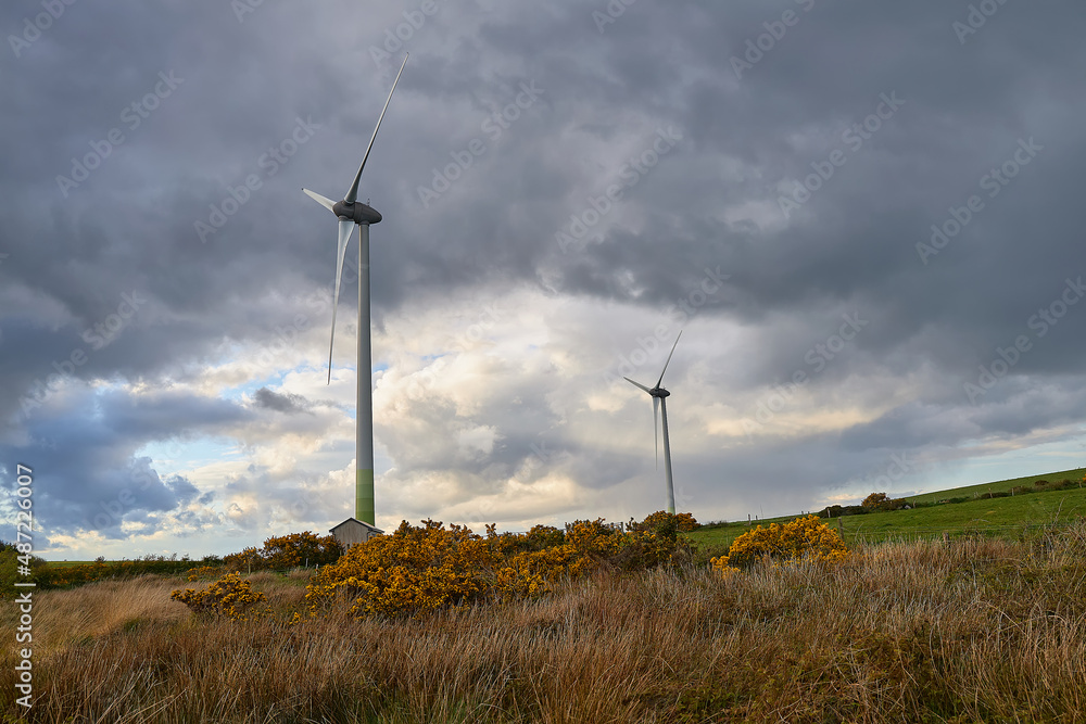 Wind turbines on the hill, Wind farm. Green ecological power energy generation. Alternative energy plant, Ireland Wind turbines on the hill, Wind farm. Green ecological power energy generation. Alternative energy plant, Ireland