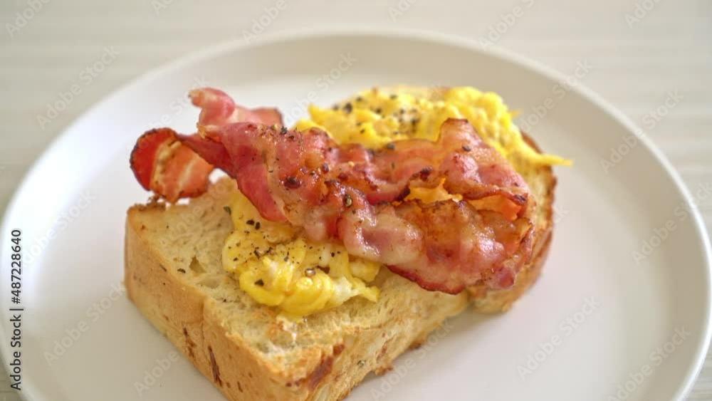 bread toasted with bacon and scrambled egg