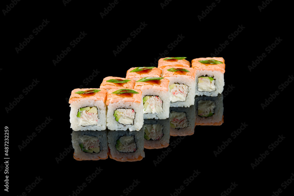 roll with baked salmon and crab on black with reflection roll with baked salmon and crab on black with reflection