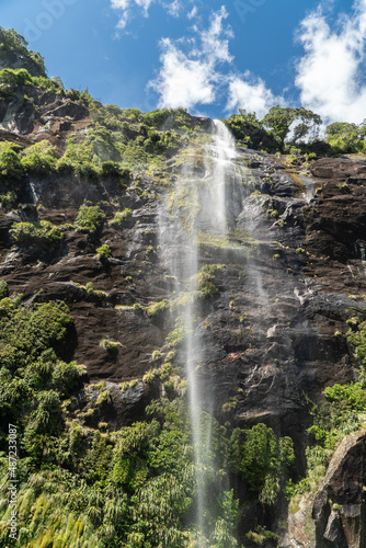 Water Rushing Down from the Rock Face in Milford Sound Fiordland National Park in the South Island of New Zealand on a Sunny Day