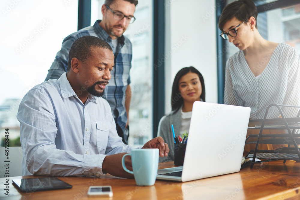 Working together to get the task done. Shot of businesspeople working together in the office. Working together to get the task done. Shot of businesspeople working together in the office.