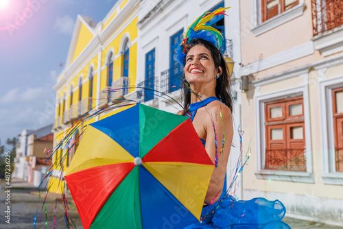 Beautiful Latin dancer dressed up for Carnival on the streets of Olinda. Frevo Recife. Brazil colors. Historical city. photo