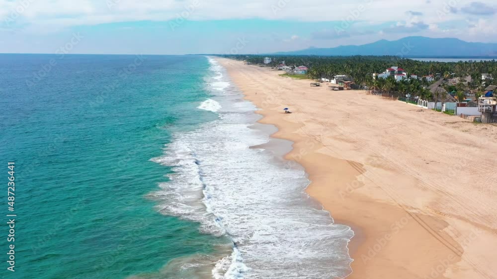 Pie de la Cuesta beach emerald sea and pristine sand beach, Acapulco Guerrero. Aerial view Pie de la Cuesta beach emerald sea and pristine sand beach, Acapulco Guerrero. Aerial view