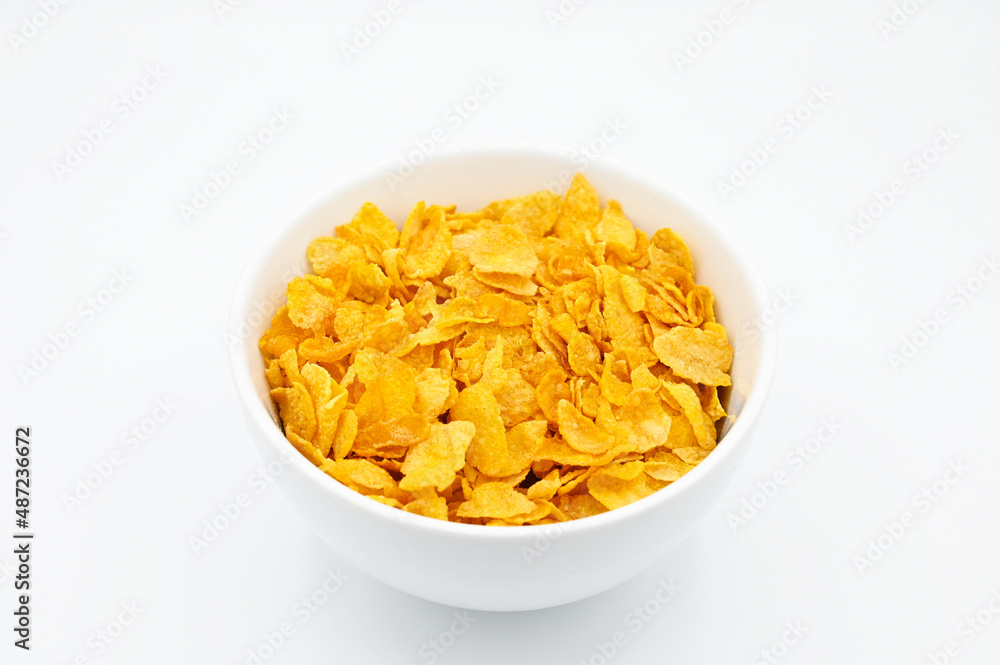 Corn Flakes, in a white bowl, isolated on a white background Corn Flakes, in a white bowl, isolated on a white background