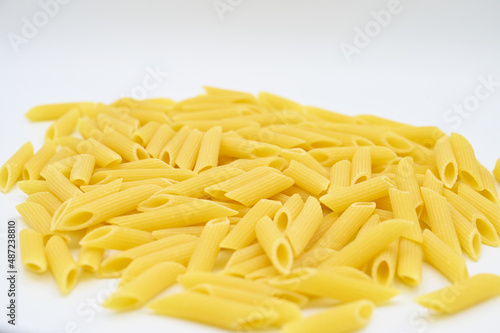 Raw penne rigate pasta, isolated on a white background 