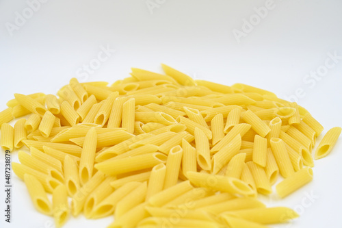 Raw penne rigate pasta, isolated on a white background 