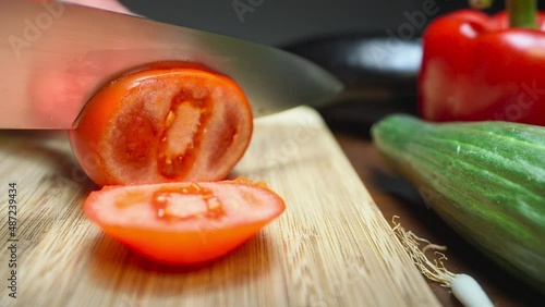 Cutting a fresh tomato with a knife