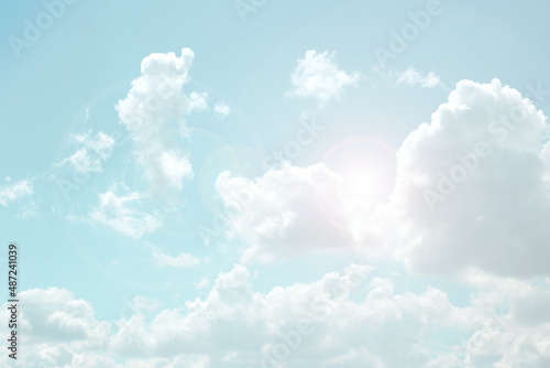  Sky. White clouds and sun rays in a light blue sky. The sky is in very light pastel colors. Heaven background.