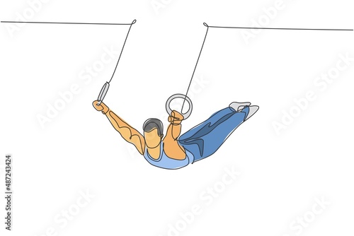 Single continuous line drawing young handsome professional gymnast man perform acrobatic motion. Steady rings training and stretching concept. Trendy one line draw design graphic vector illustration photo